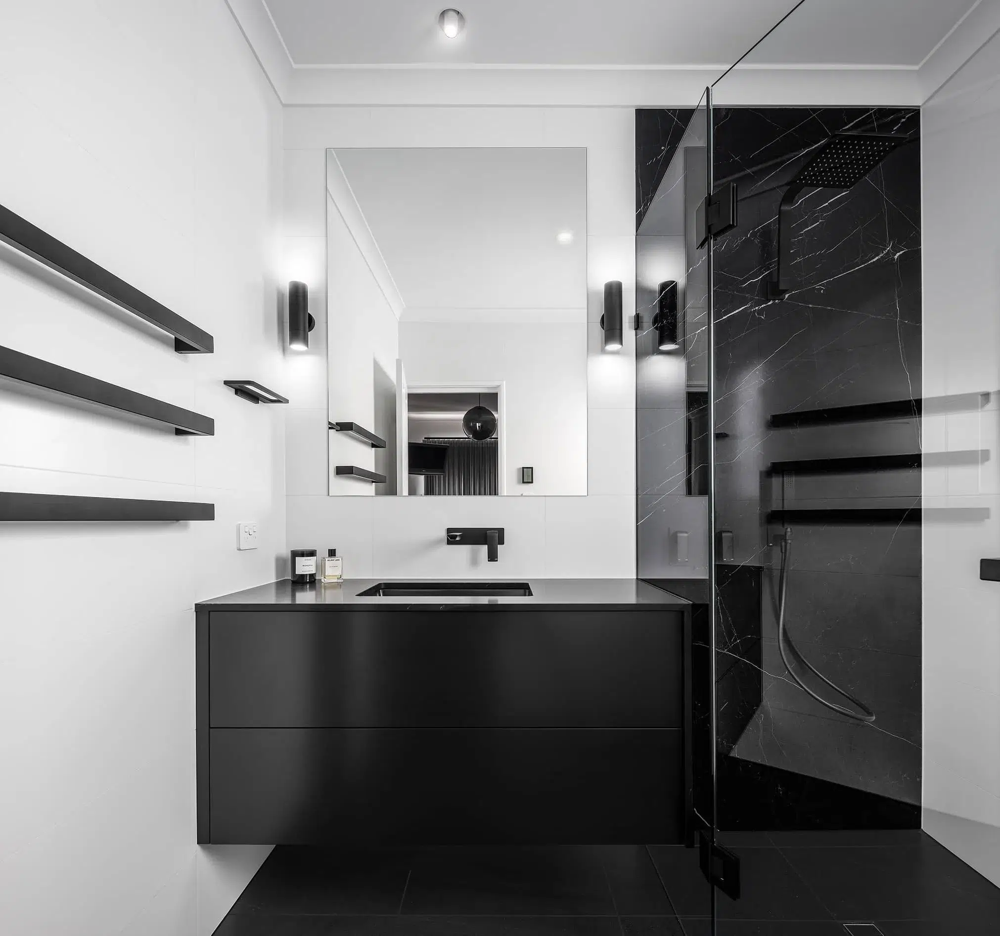 A photo of a bathroom with a black sink and shower.