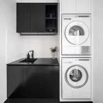 A photo of a laundry, with sink, washing machine and dryer.