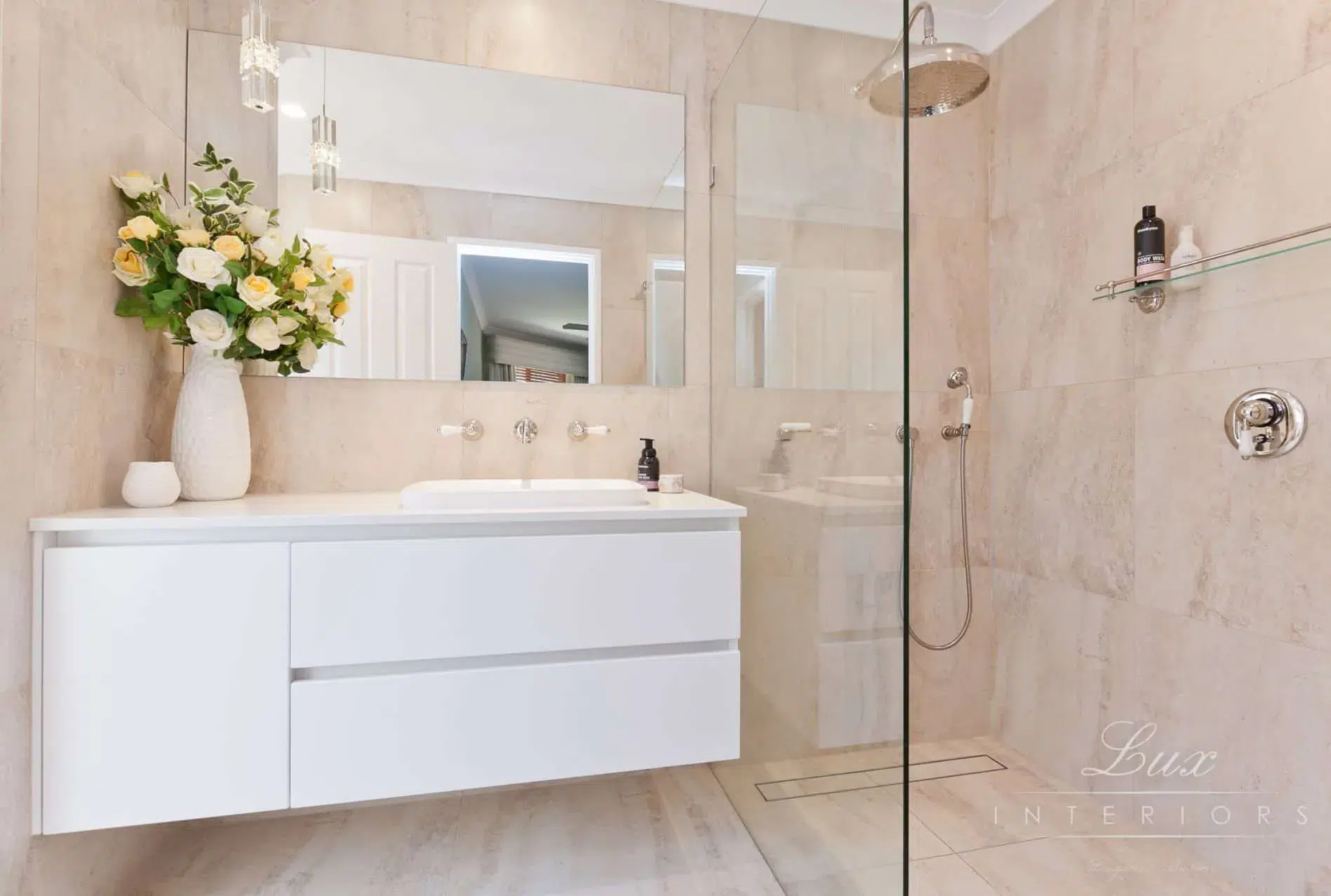 A photo of a bathroom with a sink and shower.