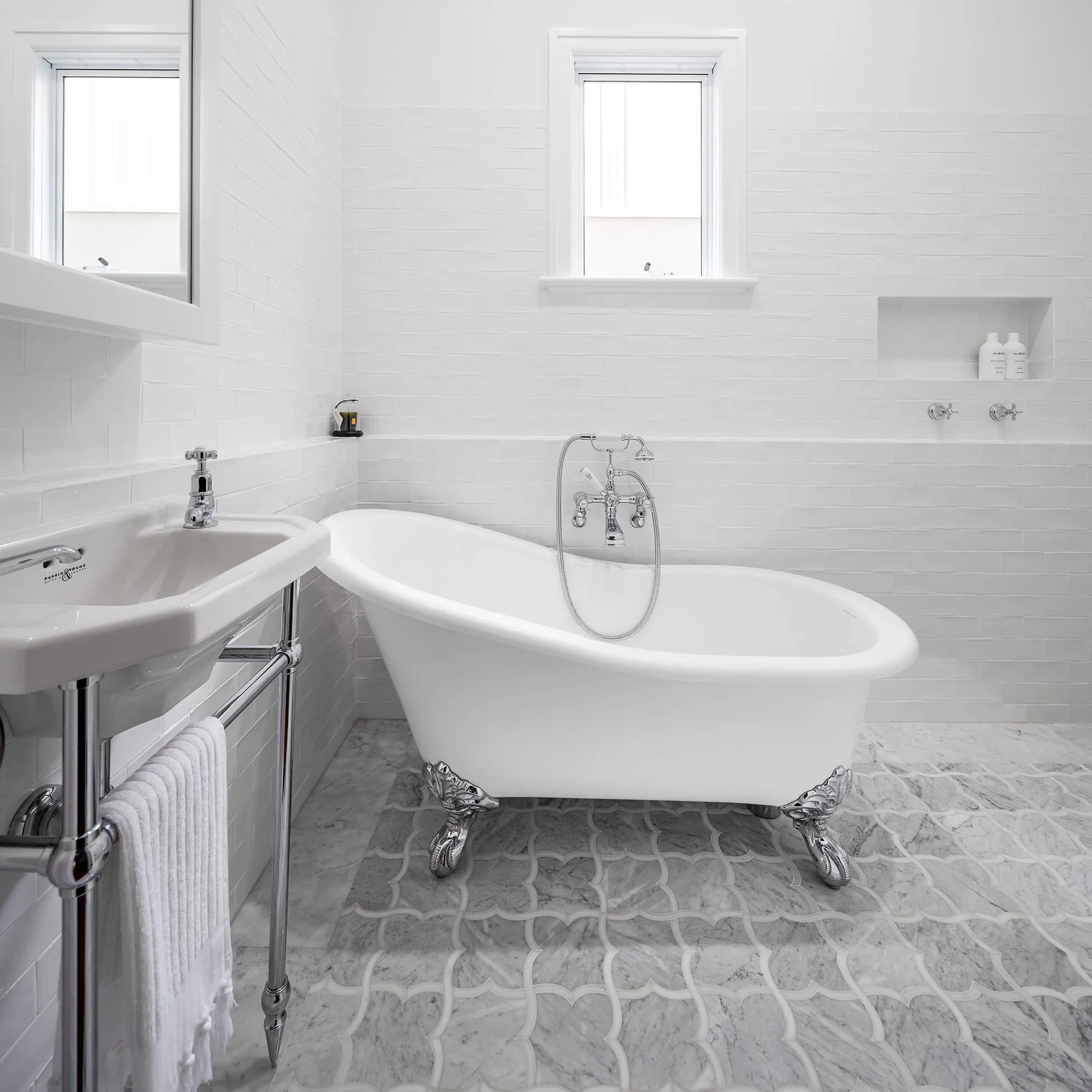 A photo of a bathroom with an imperial-looking bathtub and white look & feel.