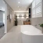 A photo of an ensuite bathroom with a bathtub, toilet and sink.