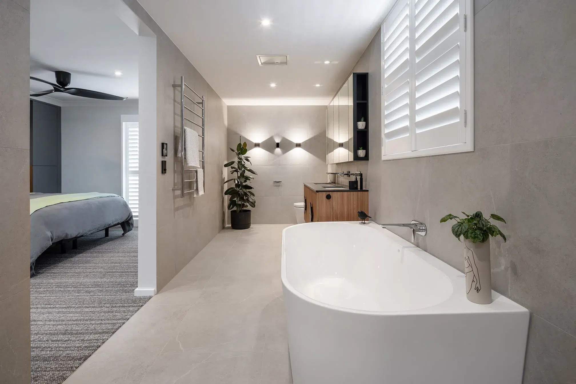 A photo of an ensuite bathroom with a bathtub, toilet and sink.