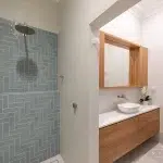 A photo of a bathroom with a shower and sink.