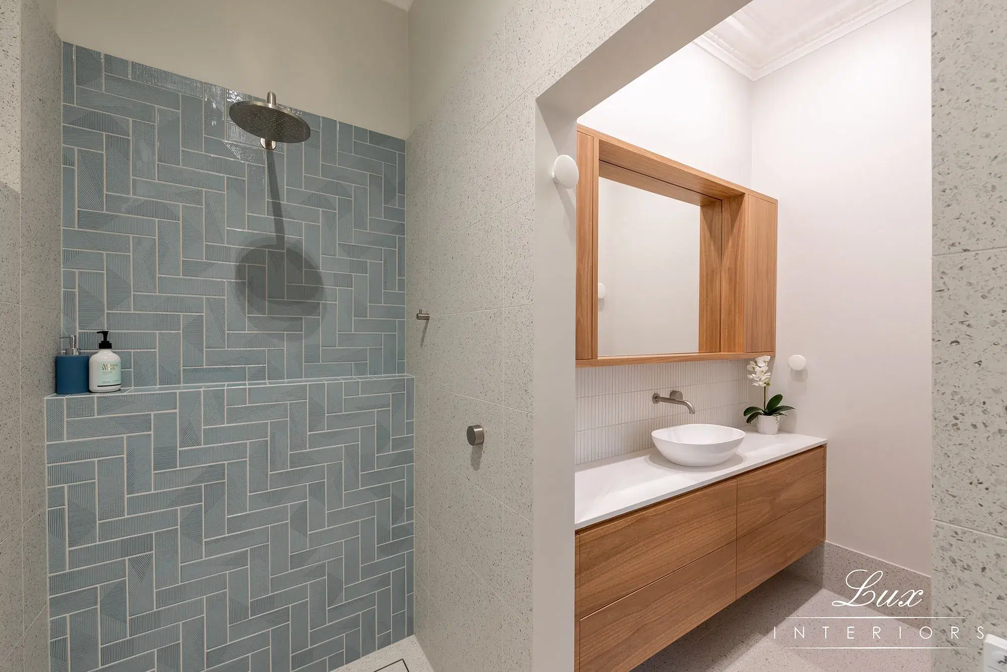 A photo of a bathroom with a shower and sink.