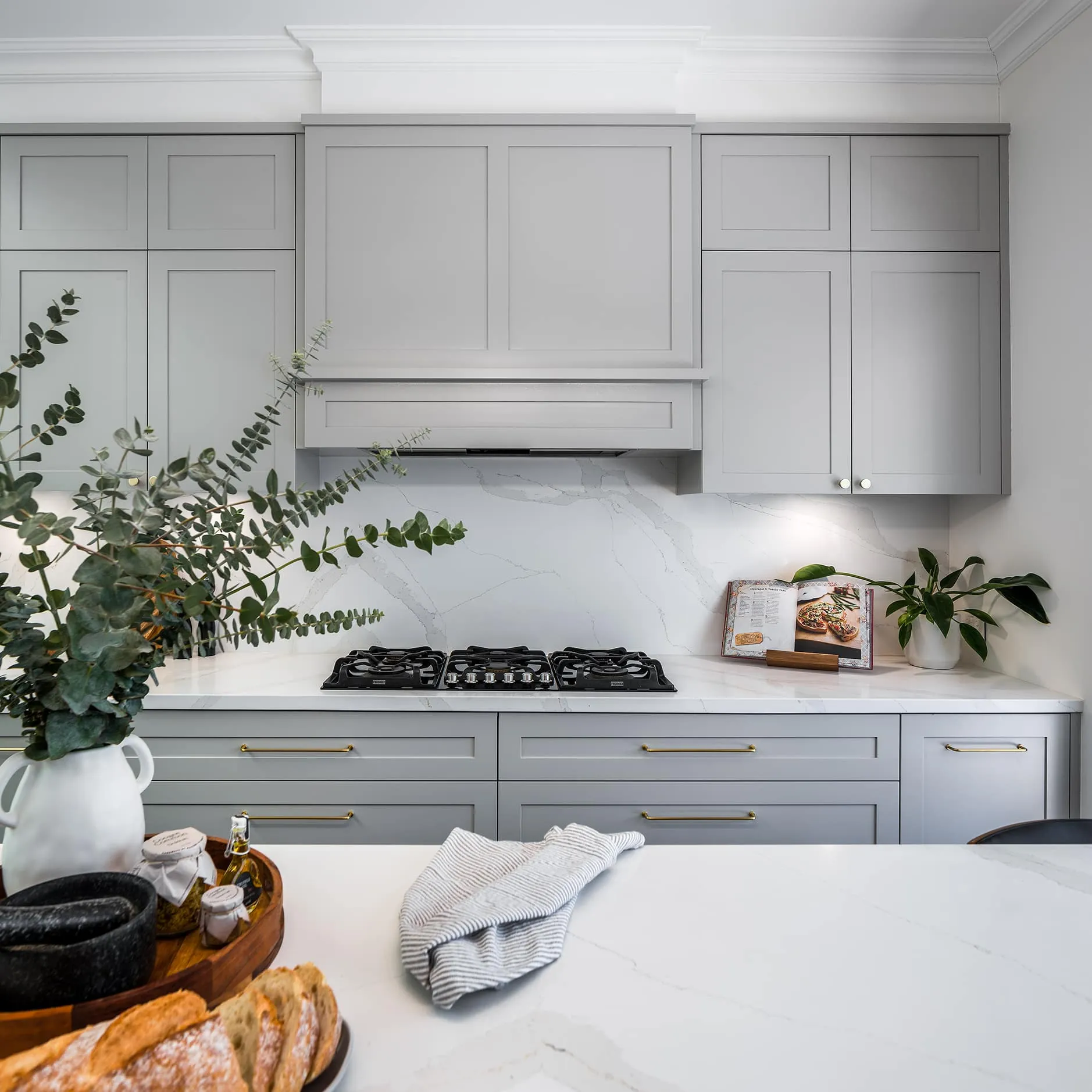 A photo of a kitchen with a stove in the background.