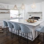 A photo of a Lux Interiors kitchen, with a dog sitting in the corner and a beautiful table top and chairs.