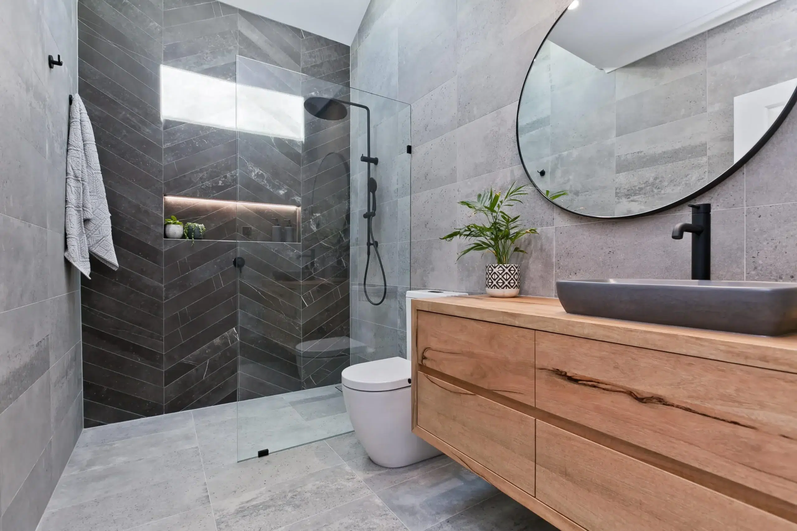 A photo of a bathroom with a shower, toilet and sink.